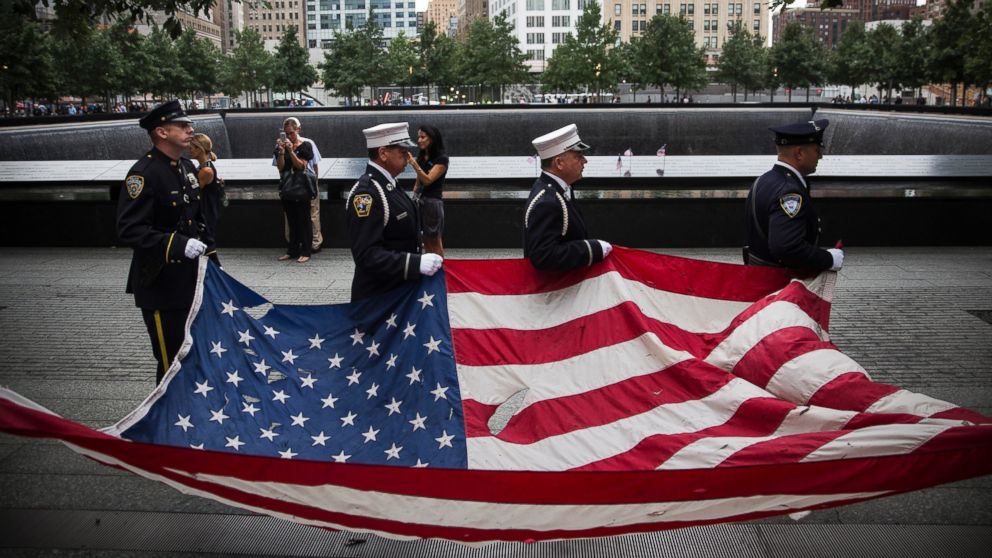 PHOTO: Members of the New York Police Department, Fire Department of New York and Port Authority of New York and New Jersey Police Department carry an American flag at the beginning of the memorial observances in New York, Sept. 11, 2014. 