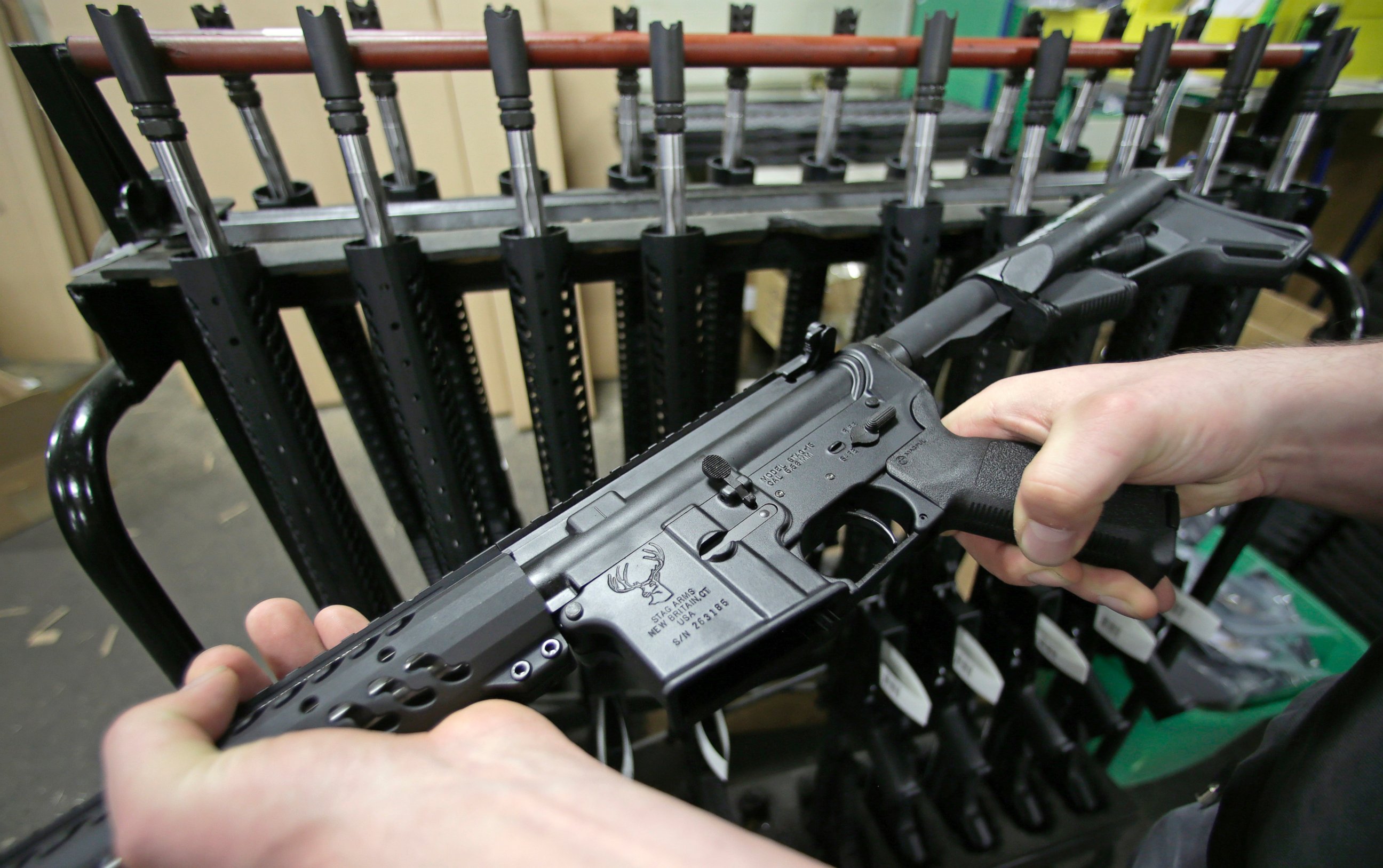 PHOTO: Craftsman Veetek Witkowski holds a newly assembled AR-15-style rifle at the Stag Arms company in New Britain, Conn. on April 10, 2013. 