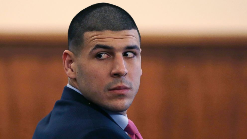 Former NFL player Aaron Hernandez looks back at the gallery during his murder trial at the Bristol County Superior Court in Fall River, Mass., Feb. 19, 2015.