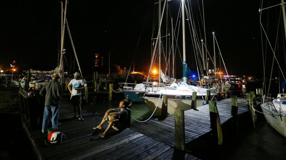Dauphin Island Regatta sailors gather near their docked sailboats Saturday, April 25, 2015, in Dauphin Island, Ala. Coast Guard officials said they responded to a report of multiple capsized vessels around 4:30 p.m. Five people are missing after several sailboats participating in a regatta capsized during a storm in Mobile Bay Saturday according to the Coast Guard.