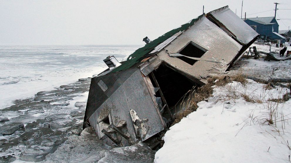 Nathan Weyiouanna's abandoned house at the west end of Shishmaref, Alaska, sits on the beach after sliding off during a fall storm in 2005.