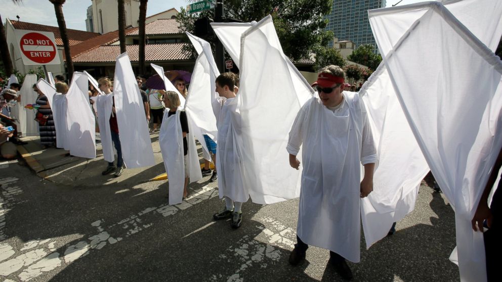 PHOTO: Counter demonstrators dressed as angels to show support and solidarity block the view of protesters near the funeral service for Christopher Andrew Leinonen, June 18, 2016, in Orlando -- one of the victims of the Pulse nightclub mass shooting.