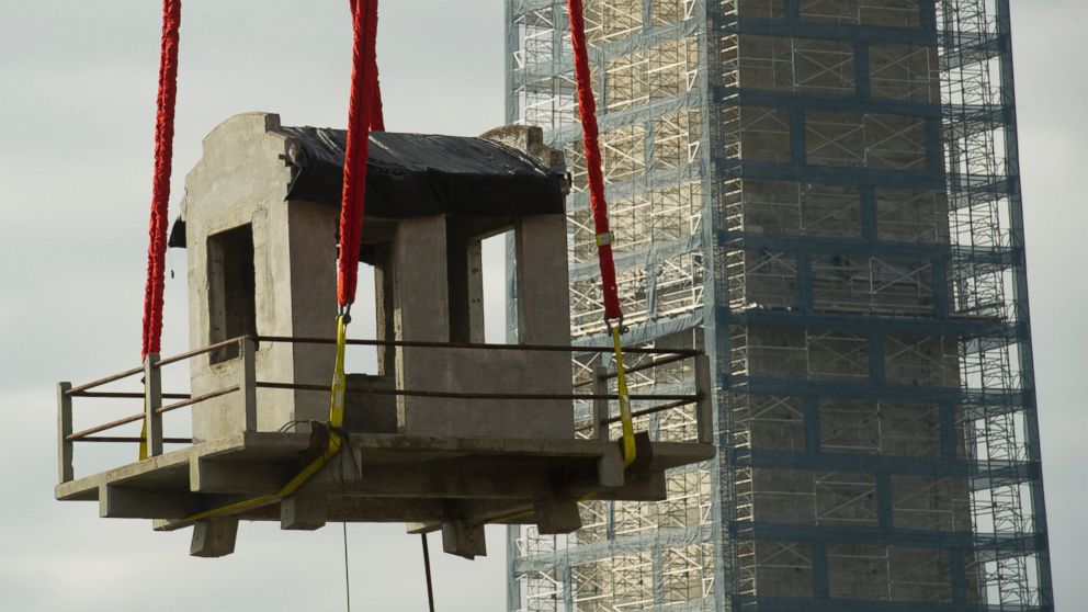 PHOTO: A guard tower from Louisiana State Penitentiary, also known as "Angola" and "The Farm" is lowered into the construction site of The National Museum of African American History and Culture in Washington, Nov. 17, 2013.