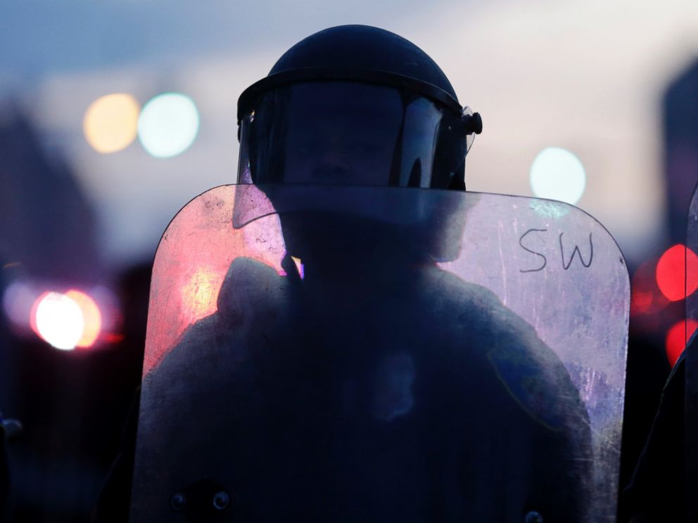 PHOTO: A police officer stands guard in Baltimore, April 27, 2015, after violence erupted in the city.