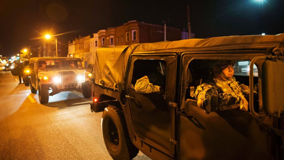 Members of the National Guard pass through Baltimore after a 10 p.m. curfew went into effect, April 28, 2015.