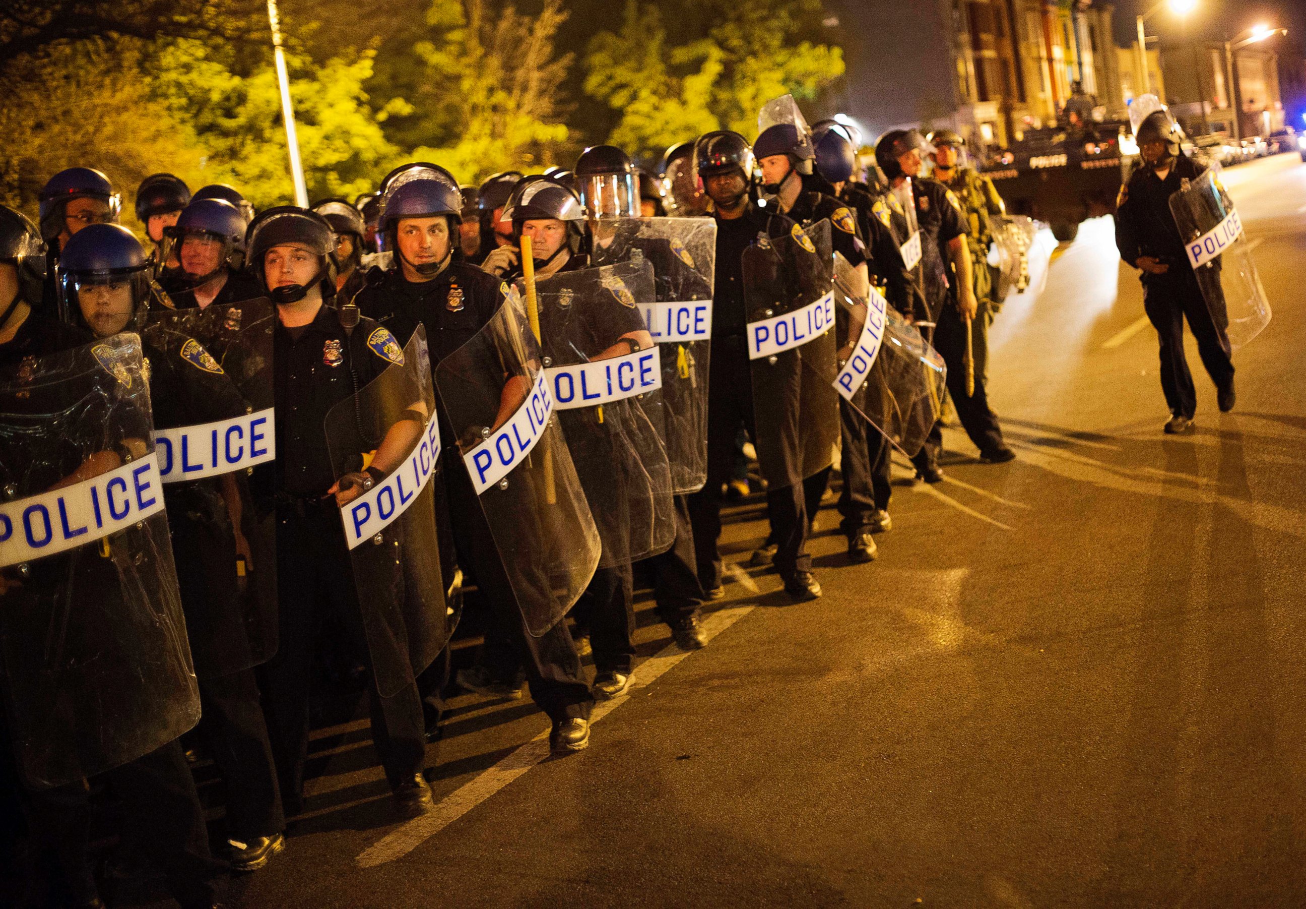 PHOTO: Police in riot gear line up near the scene of Monday's riots ahead of a 10 p.m. curfew, April 29, 2015, in Baltimore.