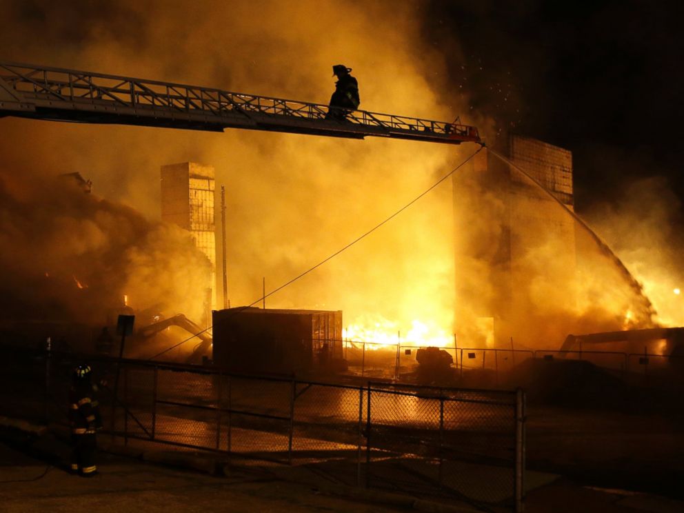 Firefighters battle a blaze, Monday, April 27, 2015, after rioters plunged part of Baltimore into chaos, torching a pharmacy, setting police cars ablaze and throwing bricks at officers.