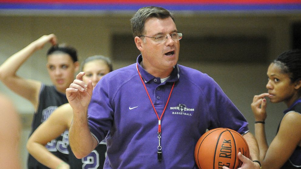 In this Nov. 4, 2010 photo, Holy Cross women's basketball coach Bill Gibbons outlines a play for his team during practice at the Hart Center in Worcester, Mass. Former Holy Cross player Ashley Cooper, 20, filed a lawsuit in New York Tuesday, Oct. 15, 2013, against the school, Gibbons, and school officials. (AP Photo/The Telegram & Gazette, Steve Lanava)