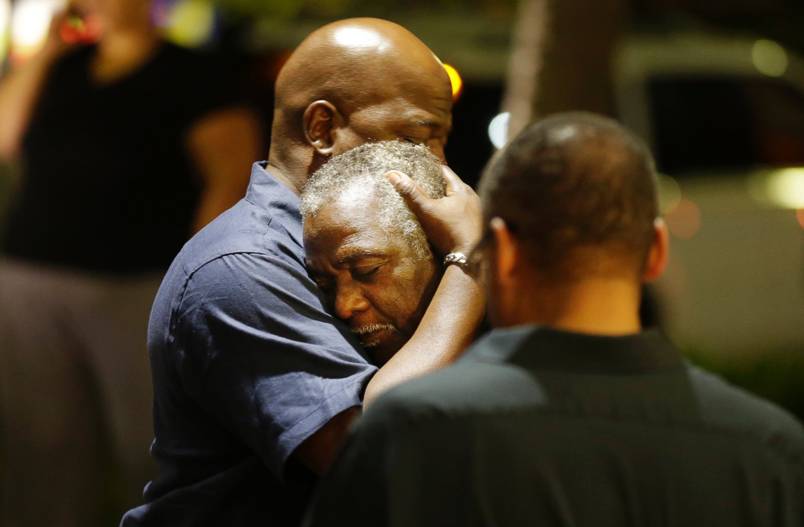 PHOTO: Worshippers embrace following a group prayer across the street from the scene of a shooting at a church in Charleston, South Carolina, June 17, 2015.