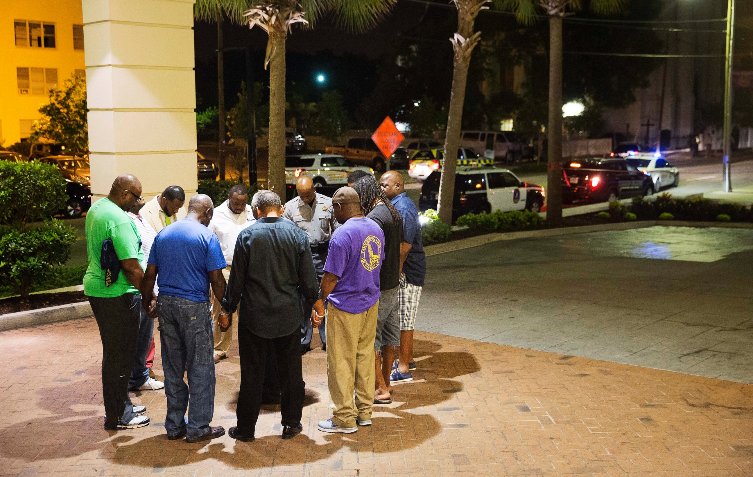 PHOTO: Worshippers gather to pray in a hotel parking lot across the street from the scene of a shooting, June 17, 2015, in Charleston, South Carolina.