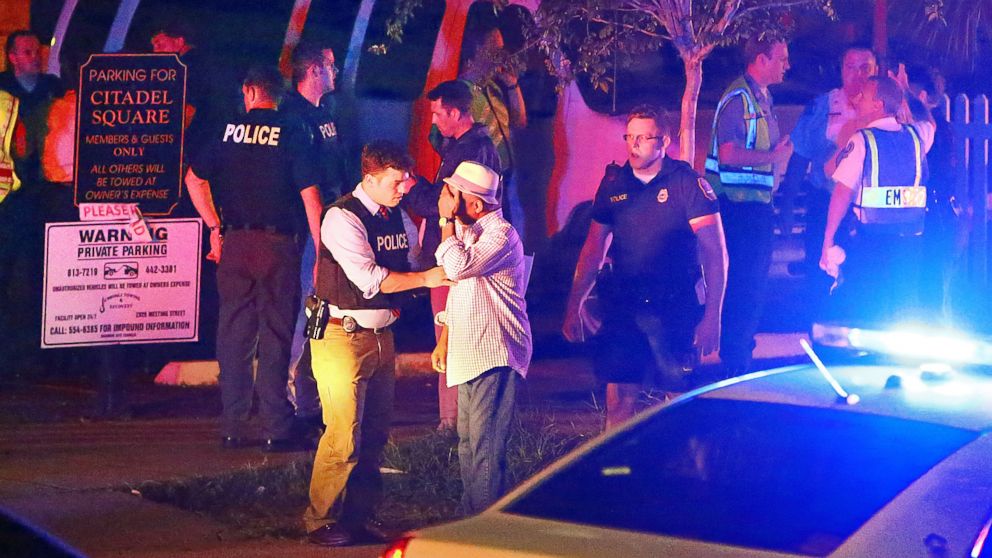Police talk to a man outside the Emanuel AME Church following a shooting, June 17, 2015, in Charleston, South Carolina.
