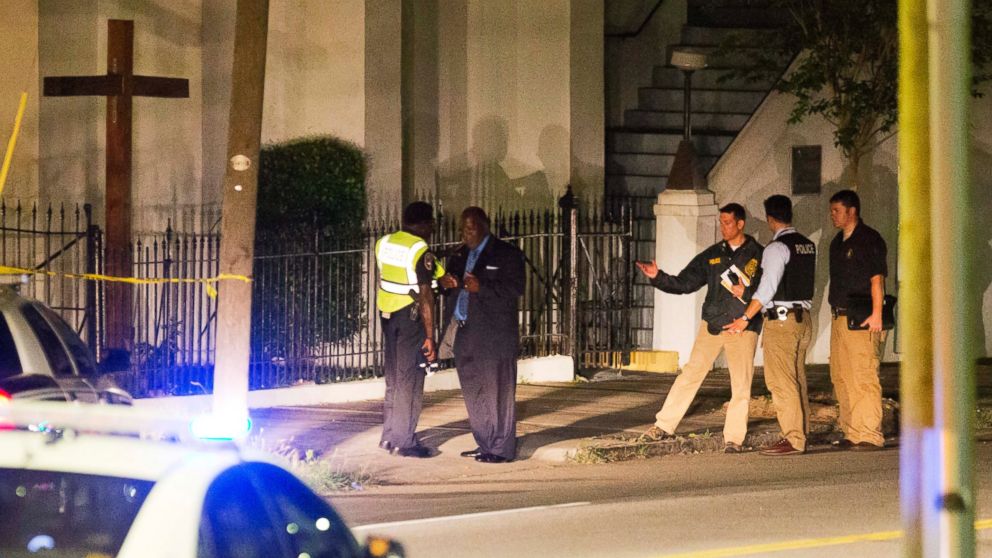 Police stand outside the Emanuel AME Church following a shooting, June 17, 2015, in Charleston, South Carolina.