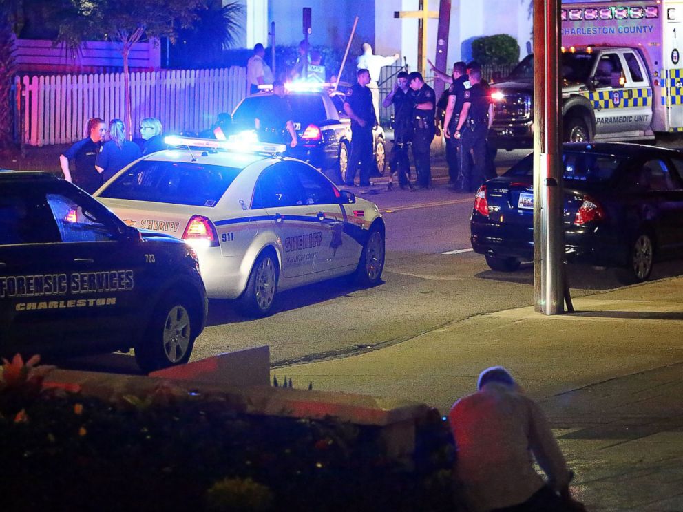 PHOTO: A man kneels across the street from where police gather outside the Emanuel AME Church following a shooting, June 17, 2015, in Charleston, South Carolina.