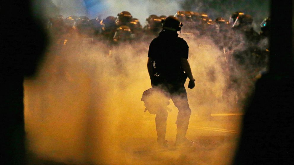Police fire teargas as protestors converge on downtown following Tuesday's police shooting of Keith Lamont Scott in Charlotte, North Carolina, Sept. 21, 2016. 