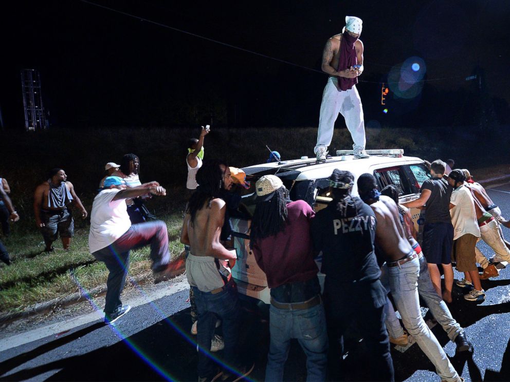 PHOTO: Protesters surround a police vehicle in Charlotte, North Carolina, Sept. 20, 2016. Authorities used tear gas to disperse protesters in an overnight demonstration that broke out Tuesday.