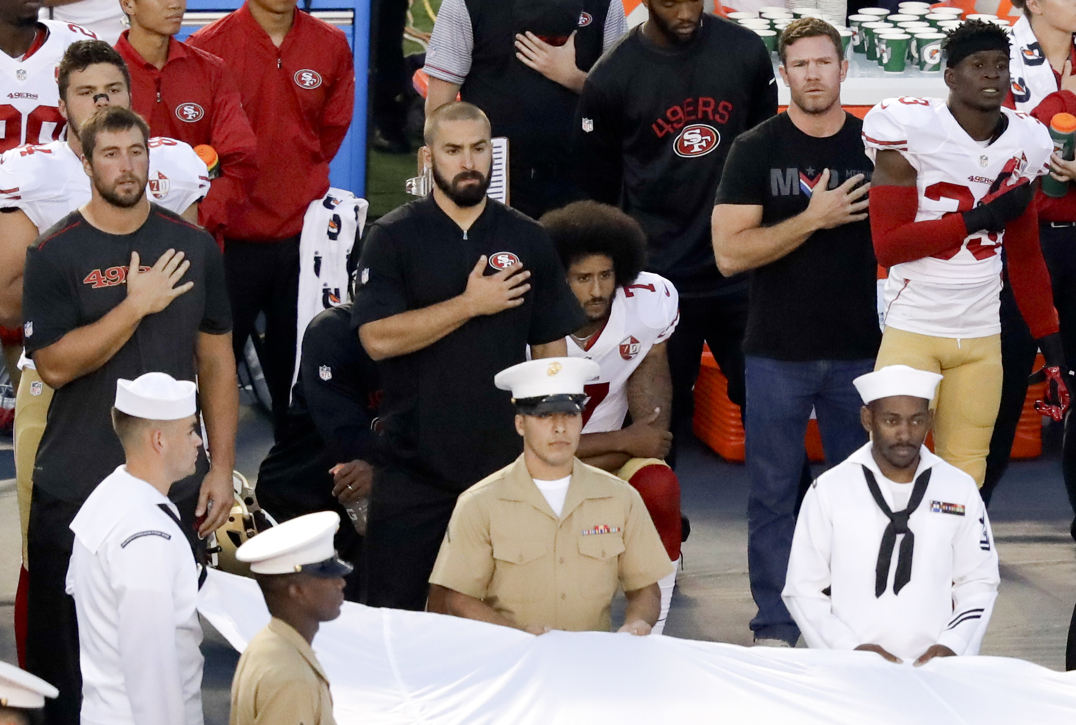 PHOTO: San Francisco 49ers quarterback Colin Kaepernick, middle, kneels during the national anthem before the team's NFL preseason football game against the San Diego Chargers, Sept. 1, 2016, in San Diego. 