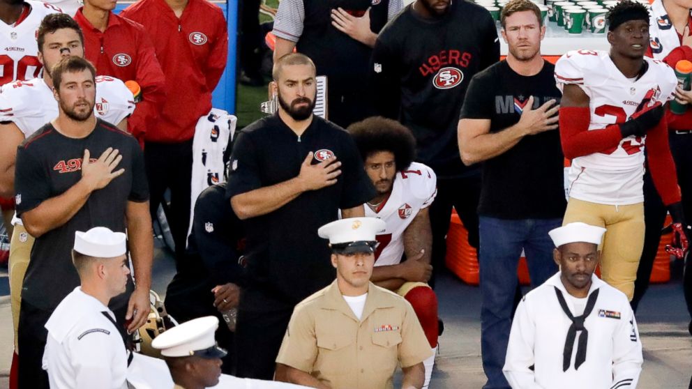 PHOTO: San Francisco 49ers quarterback Colin Kaepernick, middle, kneels during the national anthem before the team's NFL preseason football game against the San Diego Chargers, Sept. 1, 2016, in San Diego. 