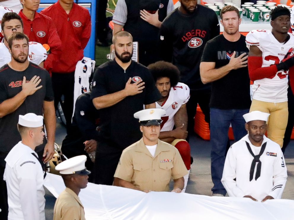 PHOTO: San Francisco 49ers quarterback Colin Kaepernick, middle, kneels during the national anthem before the teams NFL preseason football game against the San Diego Chargers, Sept. 1, 2016, in San Diego.
