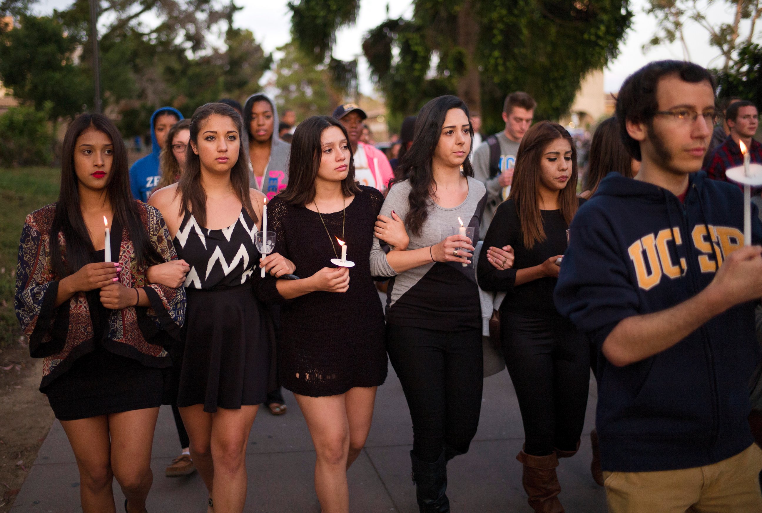 PHOTO: Students march on the campus of the University of California, Santa Barbara during a candlelight vigil held to honor the victims of Friday night's mass shooting on May 24, 2014, in Isla Vista, Calif. 