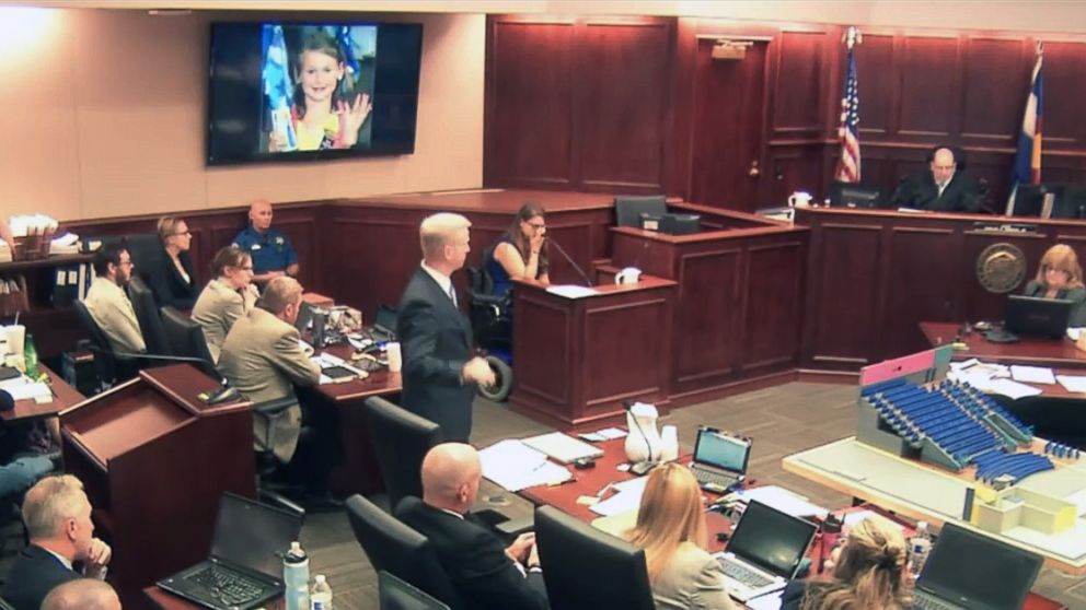 In this image taken from video, Ashley Moser, center top, who lost her 6-year-old daughter Veronica in the 2012 Colorado movie theater mass shooting, cries while testifying as a picture of her slain daughter is shown, top, during the trial of theater shooter James Holmes, pictured at top left, in Centennial, Colo., Friday, June 19, 2015. With the testimony of Moser, who was paralyzed and suffered a miscarriage in the attack, the prosecution rested its case.