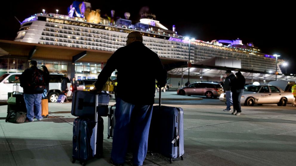A passenger from the Royal Caribbean cruise ship, Anthem of the Seas, awaits transportation after arriving at Cape Liberty cruise port, Feb. 10, 2016, in Bayonne, N.J. The ship returned early from a seven-day cruise to the Bahamas after it was battered by a major storm in the Atlantic Ocean.
