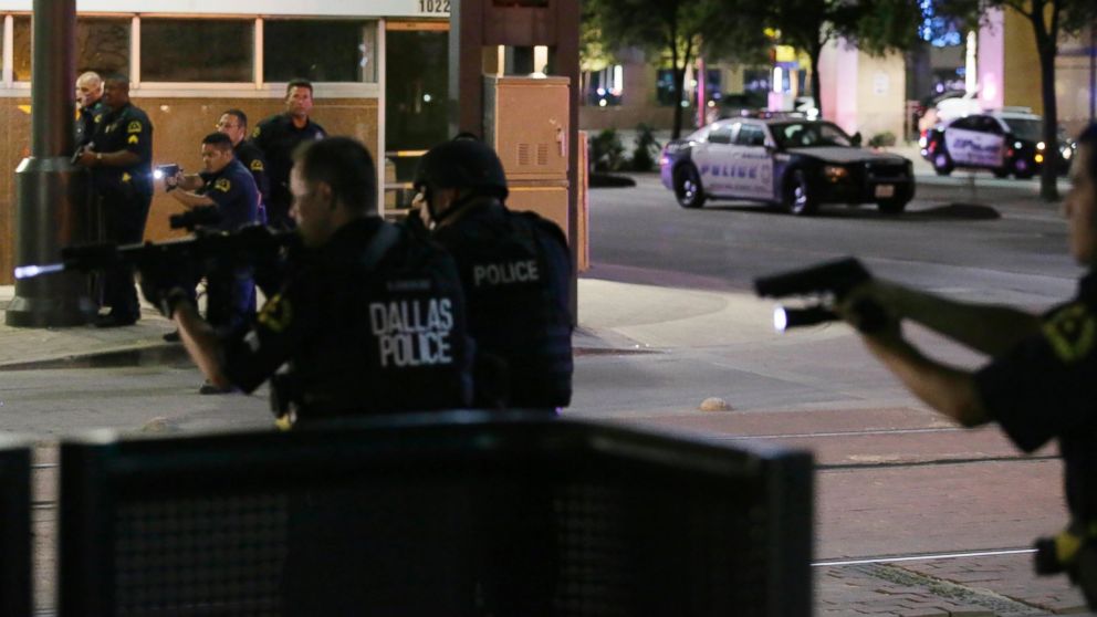 PHOTO: Dallas police move to detain a driver after several police officers were shot in downtown Dallas, July 7, 2016.