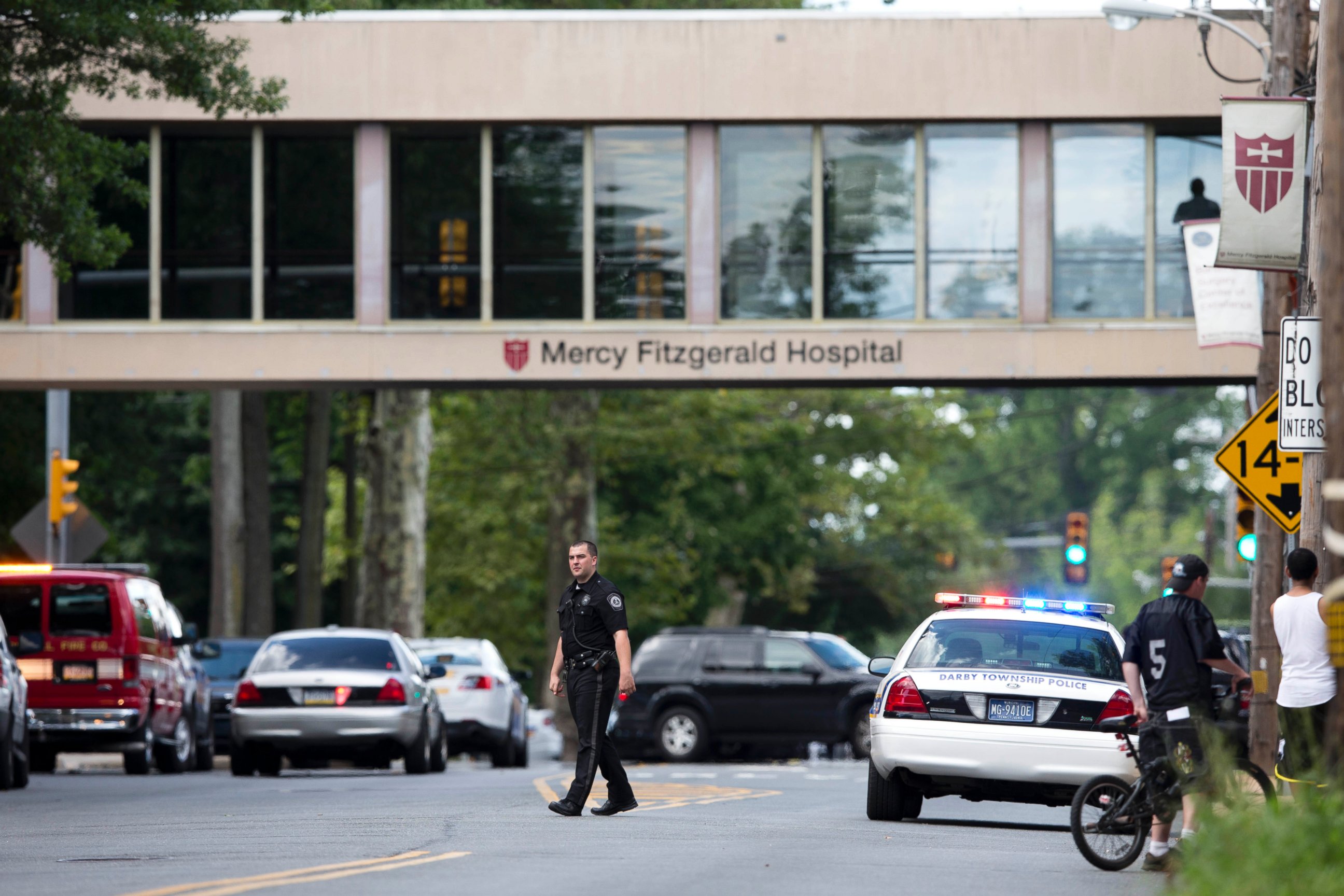 PHOTO: An officer directs traffic near the scene of a shooting Thursday, July 24, 2014, at a wellness center attached to Mercy Fitzgerald Hospital in Darby, Pa. 