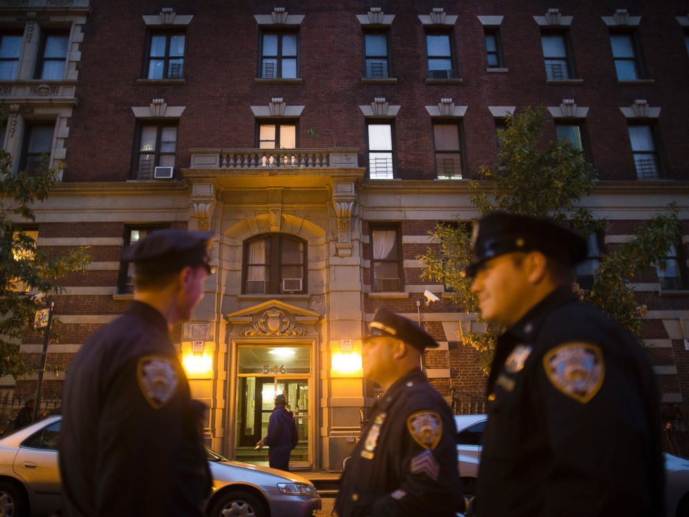 Police officers stand outside the home of Craig Spencer, a Doctors Without Borders physician who recently returned to the city after treating Ebola patients in West Africa, Oct. 23, 2014, in New York.