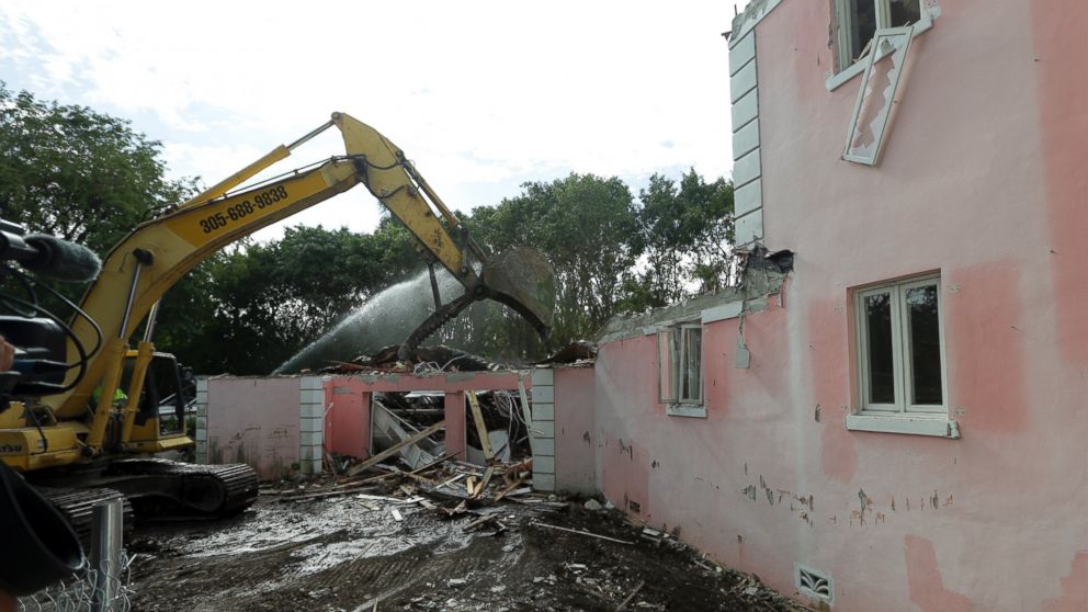 A bulldozer demolishes the waterfront mansion formerly owned by Colombian drug lord Pablo Escobar, Jan. 19, 2016, in Miami.