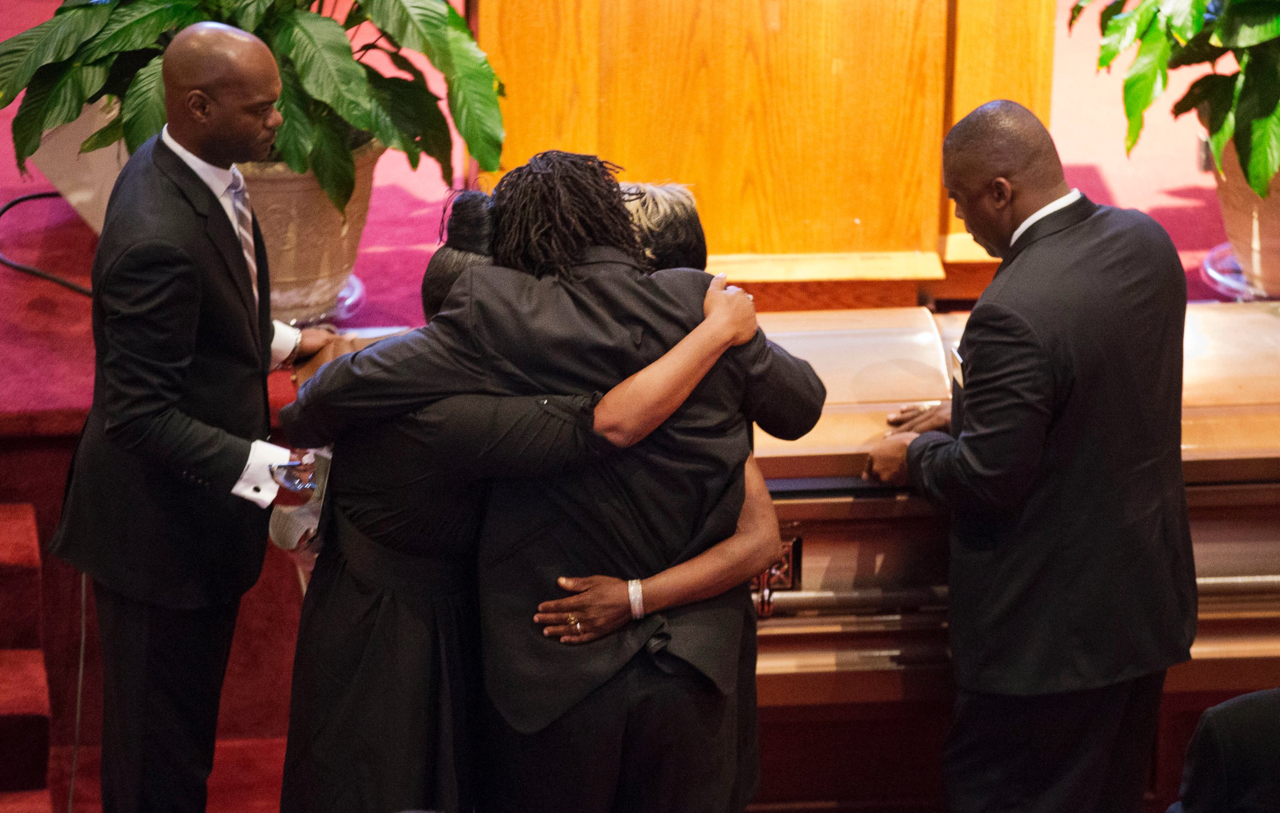 PHOTO: Family members embrace as the casket of Ethel Lance during her funeral service, June 25, 2015, in North Charleston, S.C.