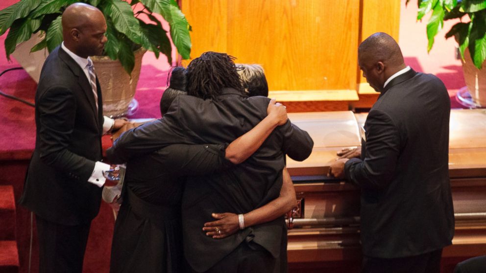 PHOTO: Family members embrace as the casket of Ethel Lance during her funeral service, June 25, 2015, in North Charleston, S.C.