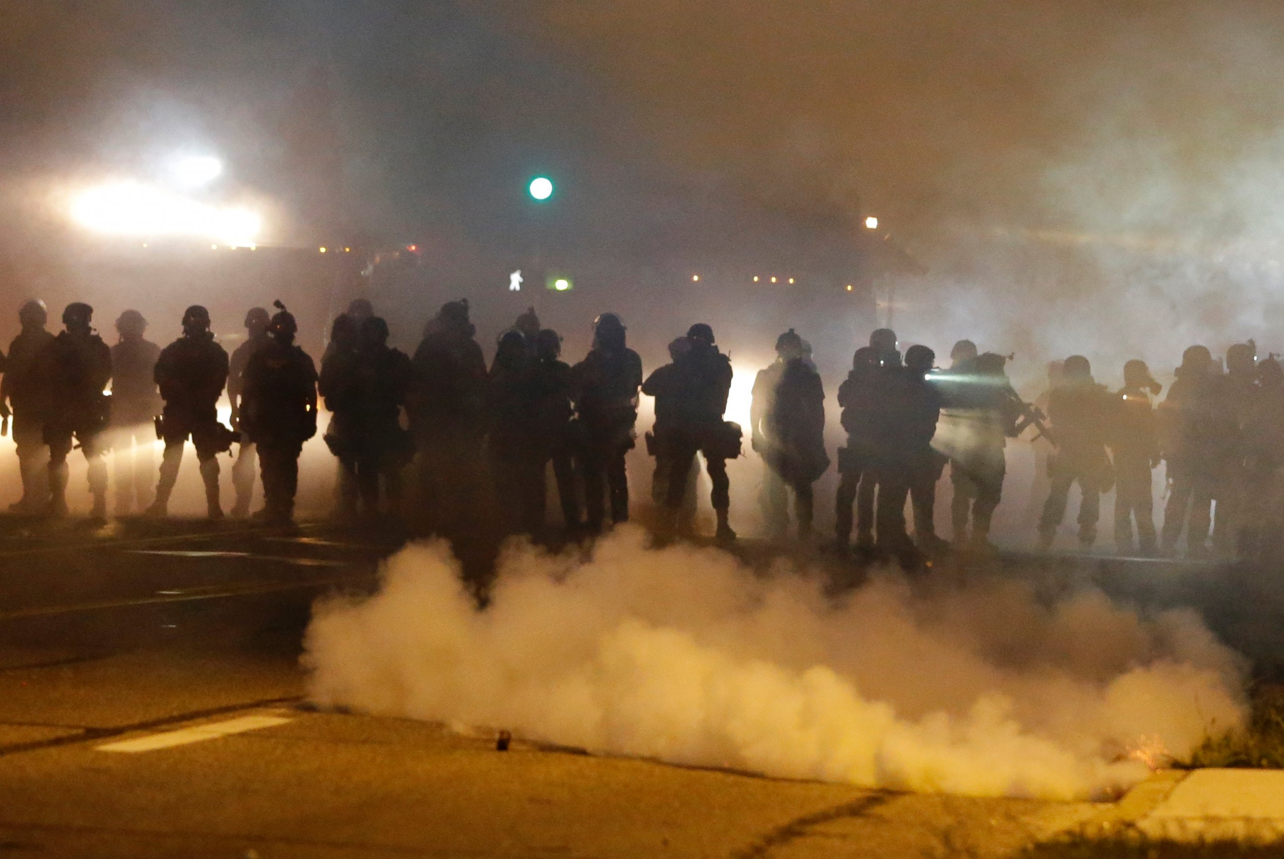 PHOTO: Police advance through smoke, Aug. 13, 2014, in Ferguson, Mo.