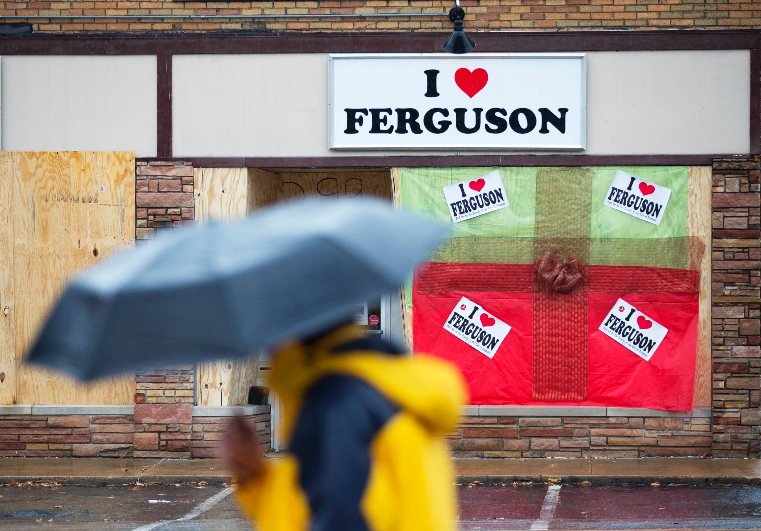 PHOTO: A pedestrian passes a boarded up storefront selling "I Love Ferguson" paraphernalia, Nov. 23, 2014, in Ferguson, Mo.