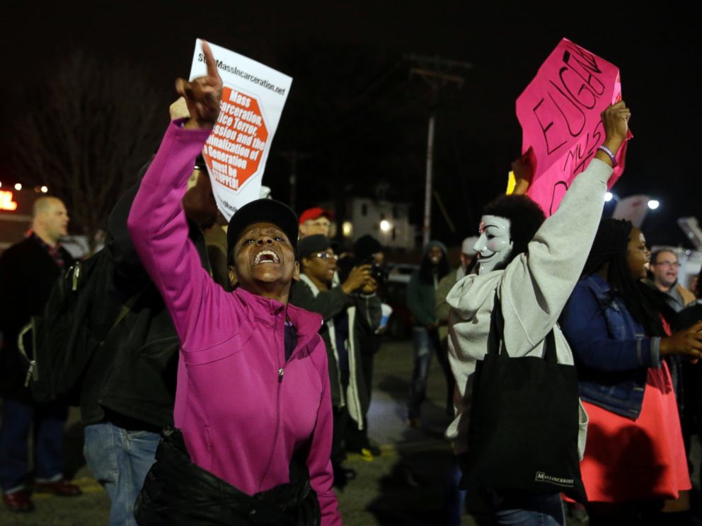 PHOTO: People demonstrate across the street from the Ferguson Police Department, March 12, 2015, in Ferguson, Mo.