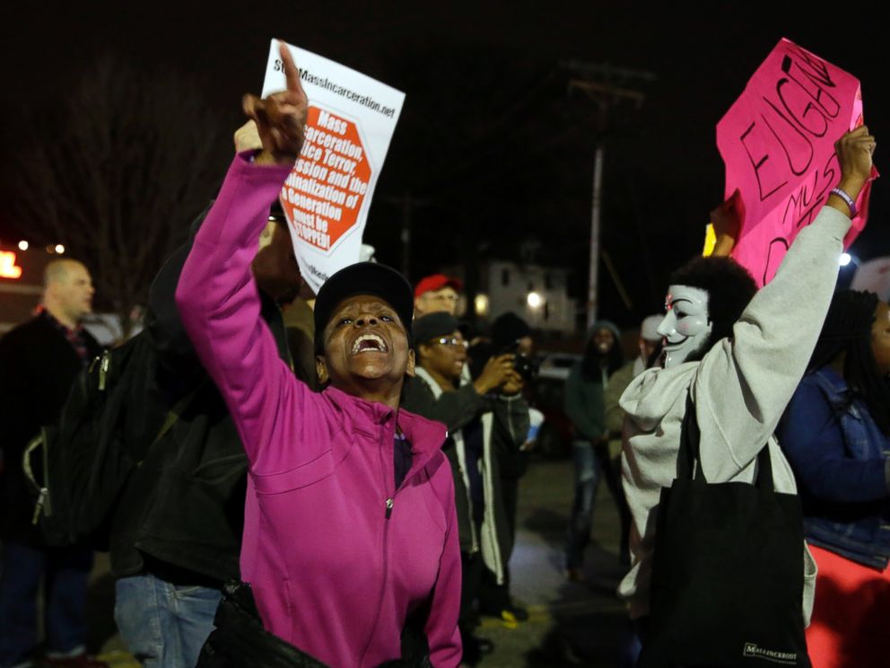 PHOTO: People demonstrate across the street from the Ferguson Police Department, March 12, 2015, in Ferguson, Mo.