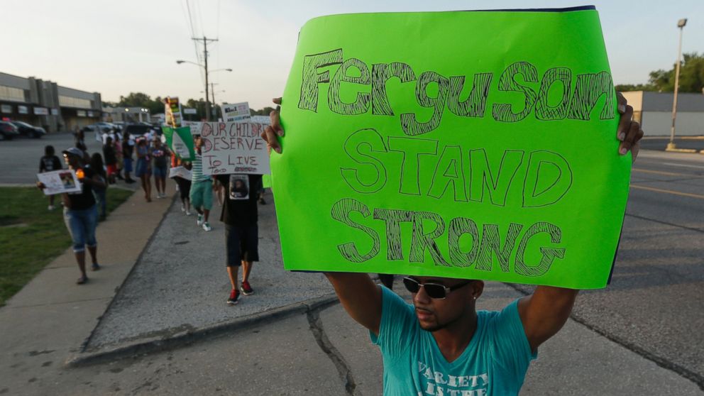PHOTO: People march to protest the shooting of Michael Brown, Aug. 20, 2014, in Ferguson, Mo.