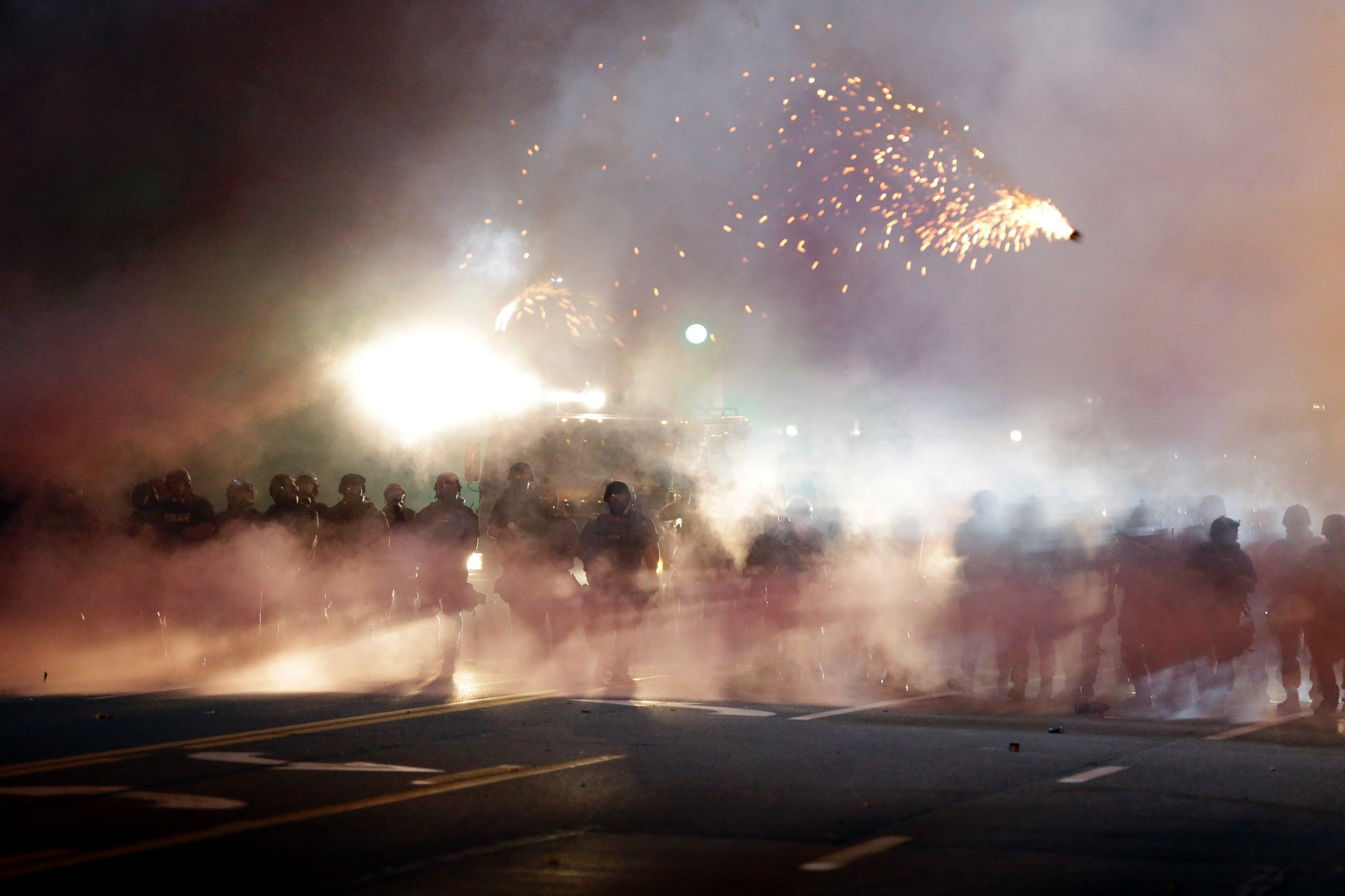 PHOTO: An explosive device deployed by police flies in the air as police and protesters clash, Aug. 13, 2014, in Ferguson, Mo.