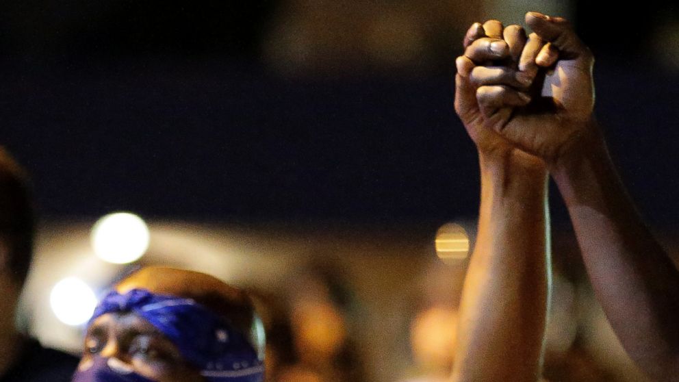 PHOTO: Protesters join hands during a protest in Ferguson, Mo., Aug. 20, 2014.