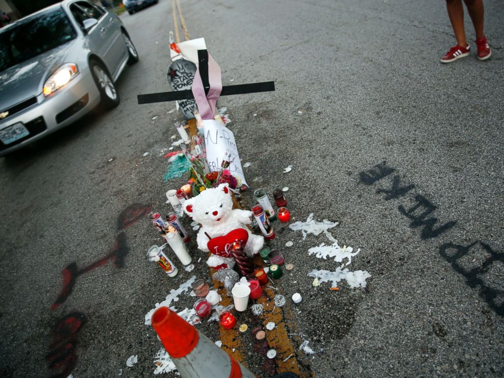 PHOTO: A makeshift memorial sits in the middle of the street where 18-year-old Michael Brown was shot and killed by police, Aug. 11, 2014, in Ferguson, Mo.