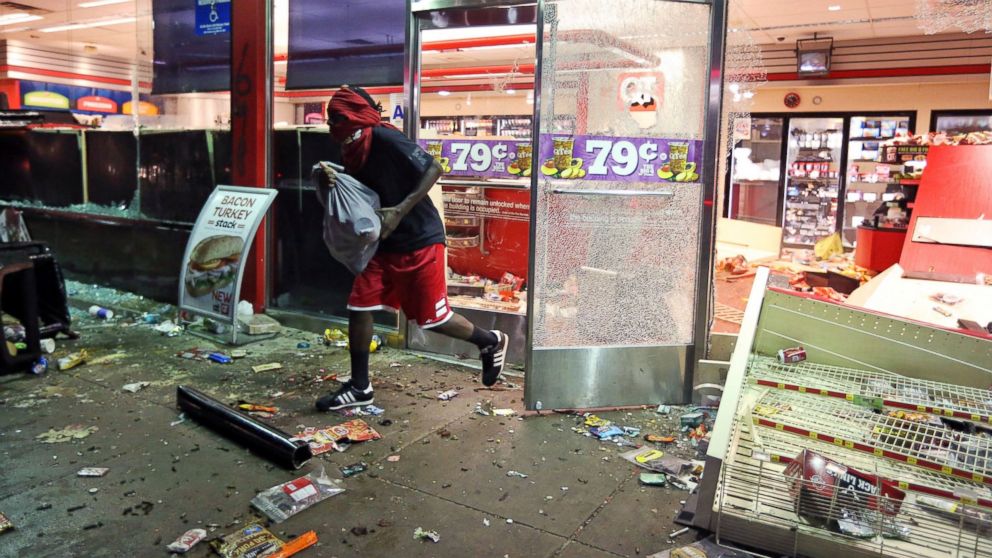 A man leaves a QuikTrip store in Ferguson, Mo., Aug. 10, 2014. The store was overrun by looters during protests for Michael Brown, 18, who was shot to death by police.