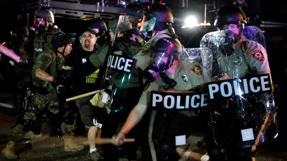 PHOTO: A man is detained after a standoff with police, Aug. 18, 2014, in Ferguson, Mo.