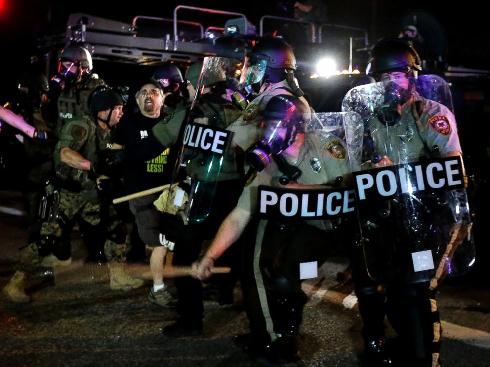 PHOTO: A man is detained after a standoff with police, Aug. 18, 2014, in Ferguson, Mo.