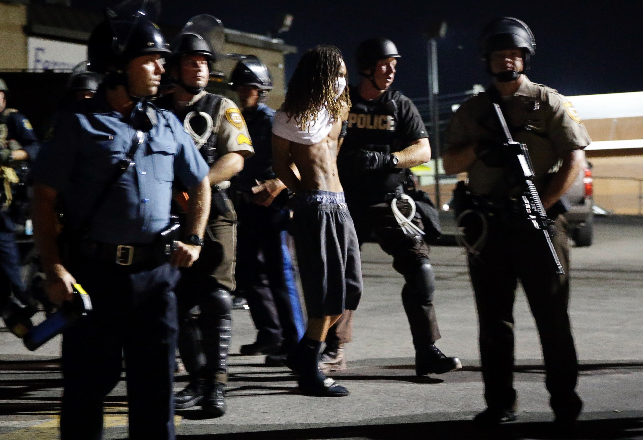 PHOTO: A man is arrested as police try to disperse a crowd in Ferguson, Mo., Aug. 20, 2014.