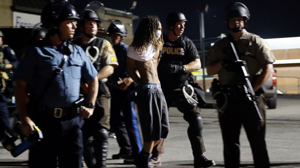 PHOTO: A man is arrested as police try to disperse a crowd in Ferguson, Mo., Aug. 20, 2014.