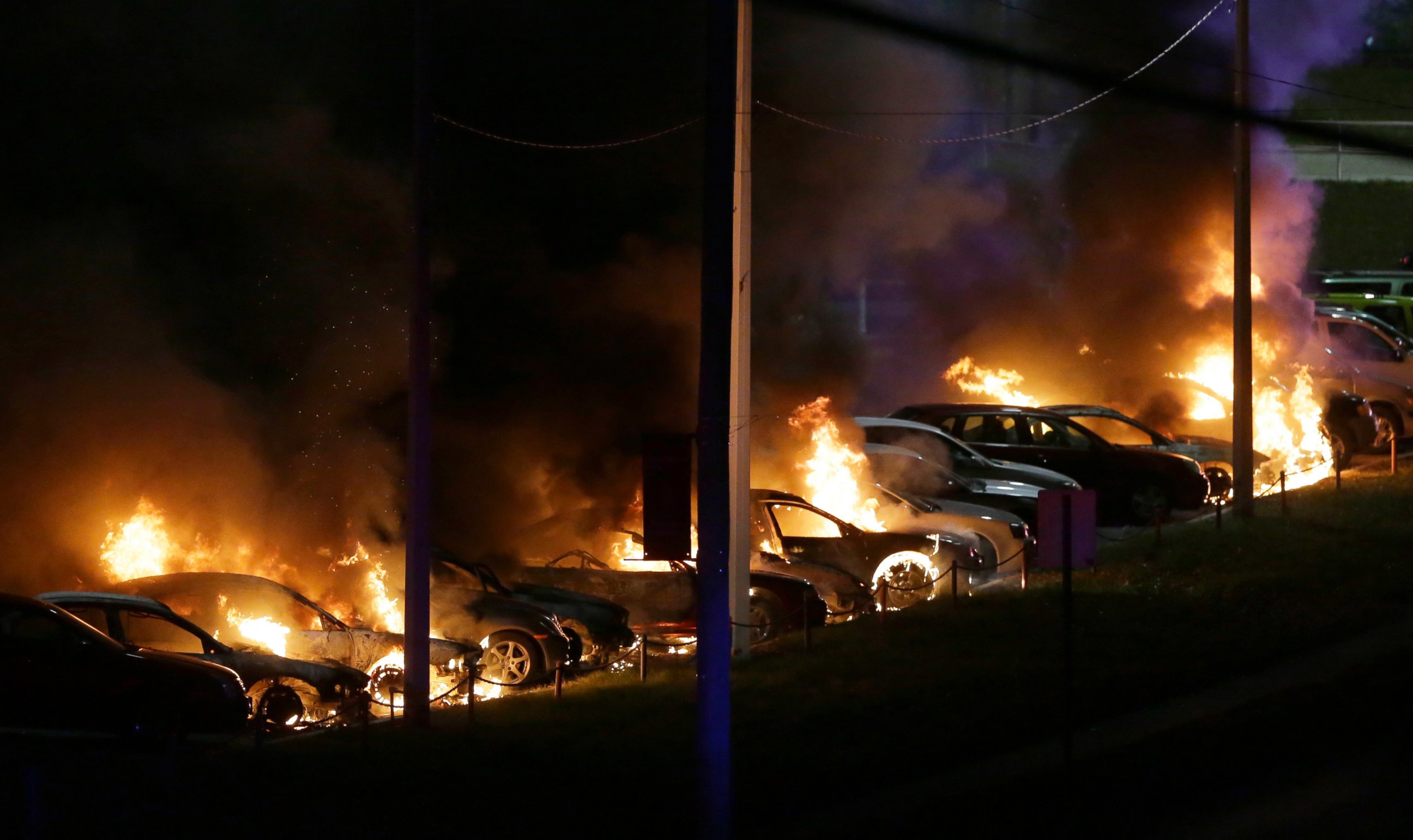 PHOTO: Cars burn at a used car dealership, Nov. 25, 2014, in Dellwood, Mo.