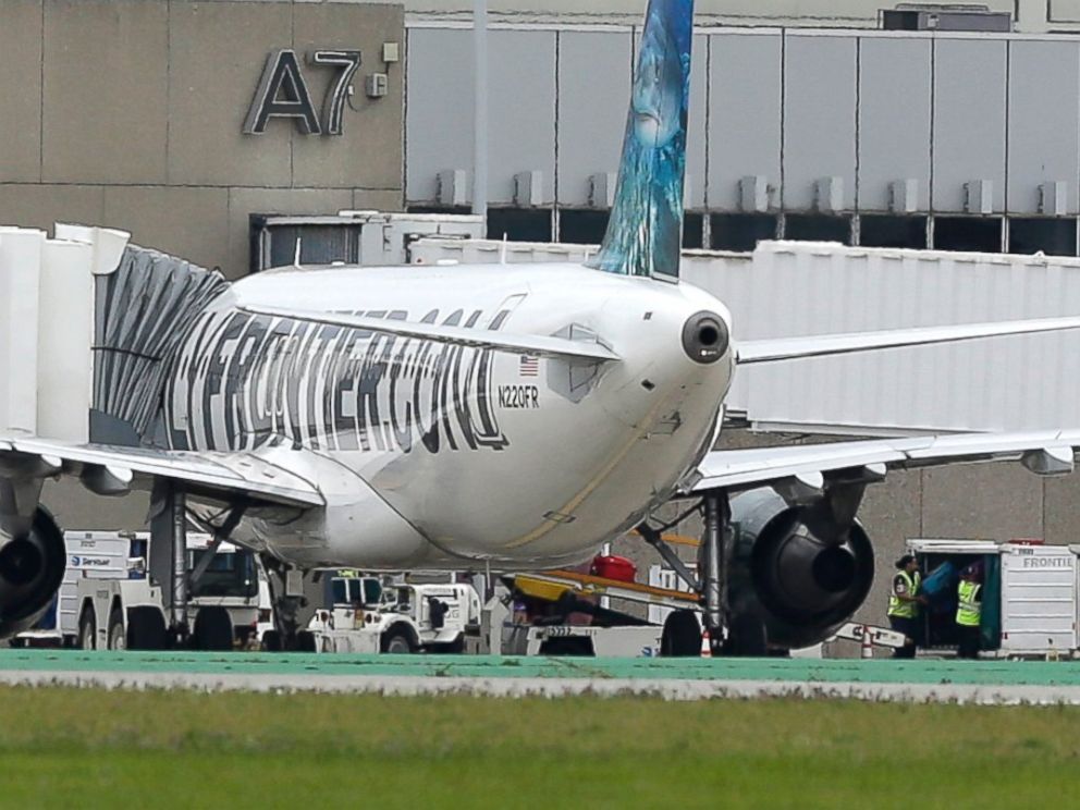 PHOTO: Two workers unload bags from the Frontier Airlines plane that Amber Vinson traveled in from Cleveland to Dallas, at a terminal at Cleveland Hopkins International Airport, Oct. 15, 2014, in Cleveland.