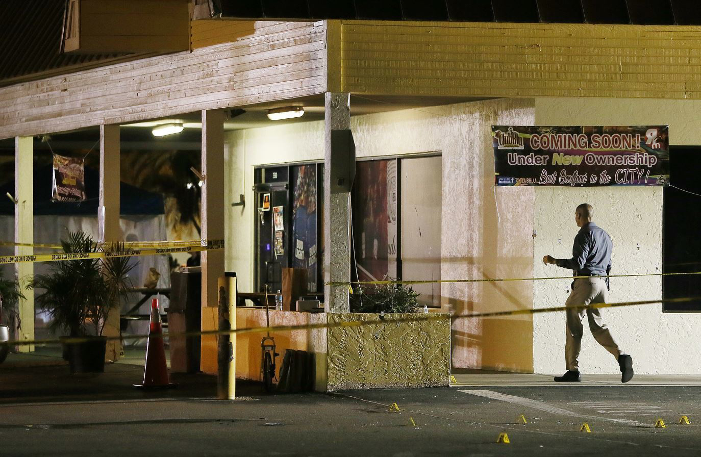 PHOTO: An investigator walks near the scene of a fatal shooting at Club Blu nightclub in Fort Myers, Florida, July 25, 2016.