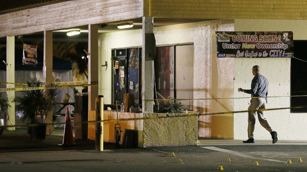 An investigator walks near the scene of a fatal shooting at Club Blu nightclub in Fort Myers, Florida, July 25, 2016.