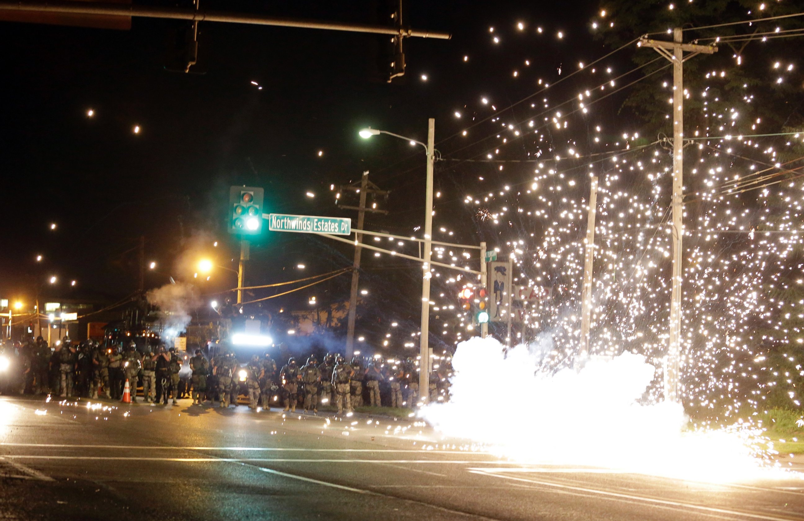 PHOTO: A device deployed by police goes off in the street as police and protesters clash Wednesday, Aug. 13, 2014, in Ferguson, Mo., the St. Louis suburb where an unarmed black teen was shot and killed by a police officer.