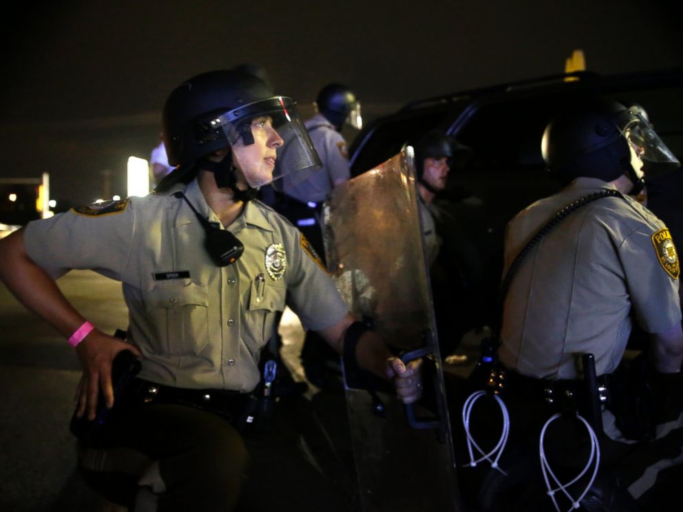PHOTO: Police take cover after gunfire near a protest in Ferguson, Mo., Sunday, Aug. 9, 2015.